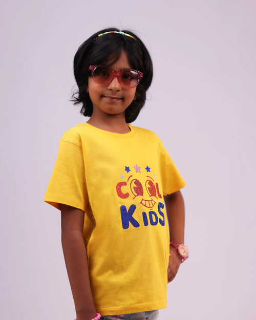 Front view of yellow “Cool Kids” tee for unisex children—fun and comfy