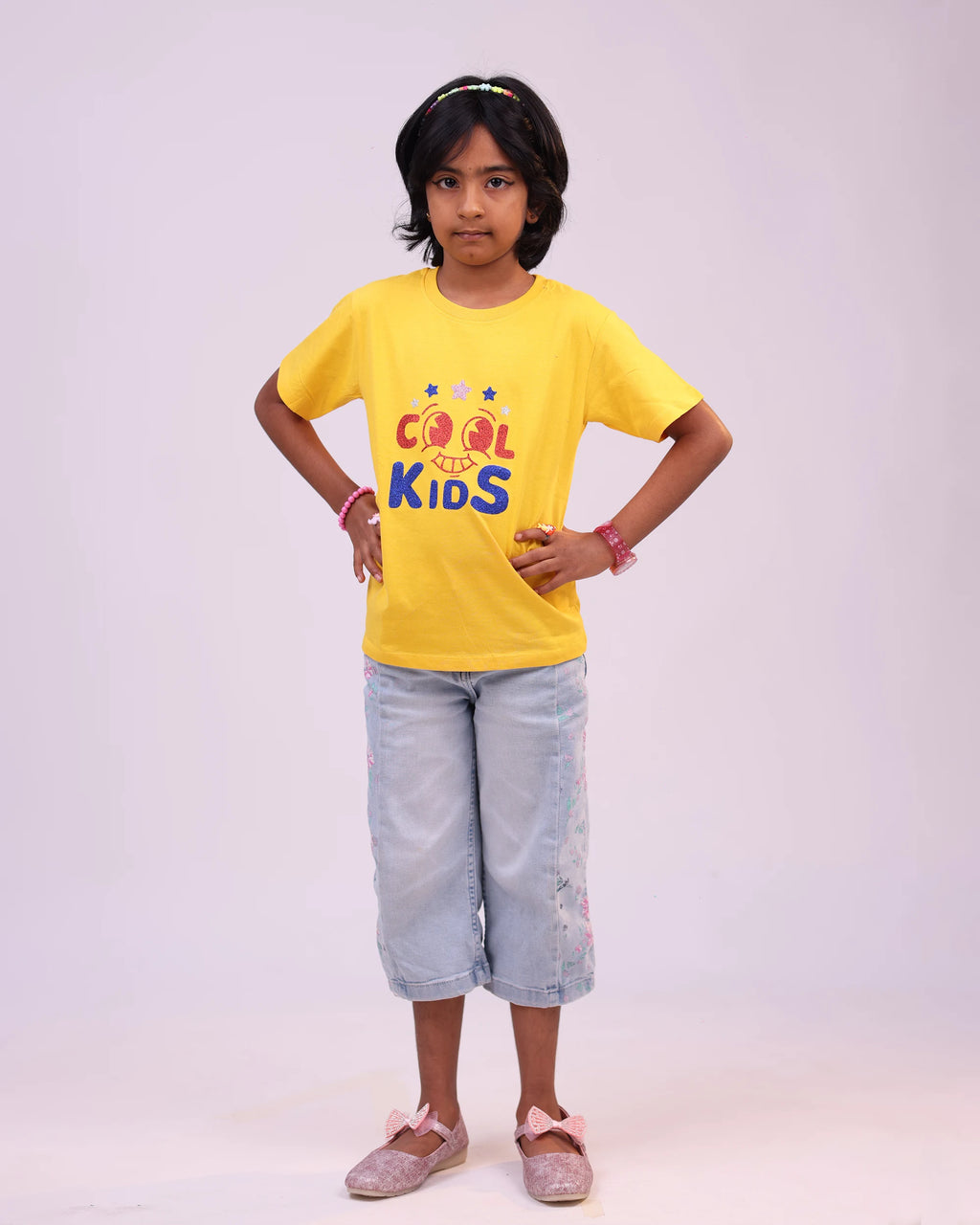 Close-up of “Cool Kids” print on soft yellow cotton tee